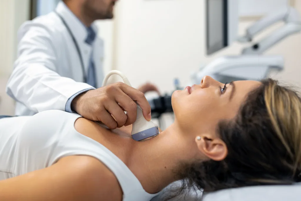 close-up-shot-young-woman-getting-her-neck-examined-by-doctor-using-ultrasound-scanner-modern-clinic-min THS baja