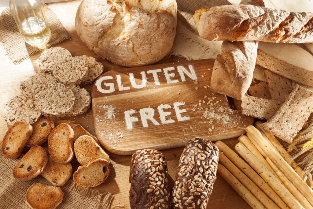 Gluten free food. Various pasta, bread and snacks on wooden background from top view intolerancia al gluten