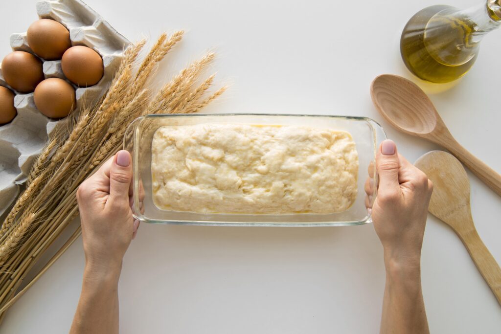 top-view-hands-holding-cake-mould-with-batter-min gluten free